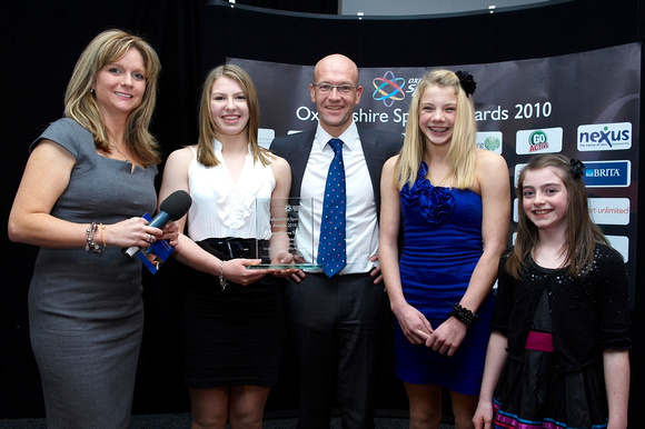 Becky, Becca and Freya receive the Junior Sports Team of the Year trophy from BBC Oxford