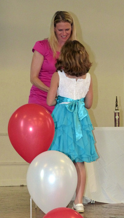 Samara receives her trophy from Emma
